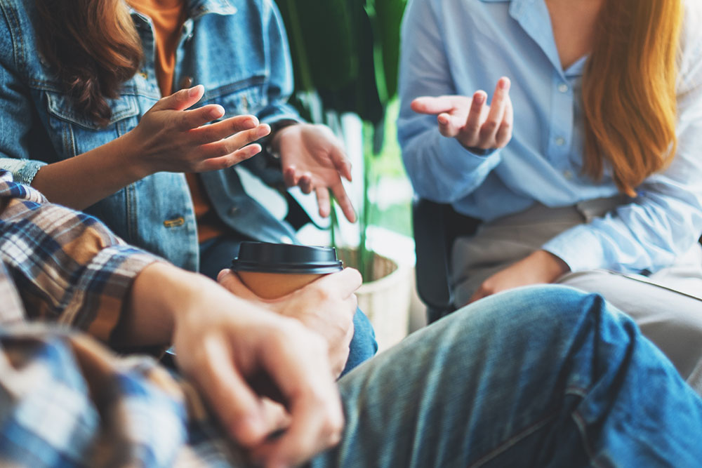 A group of young people sitting and talking together